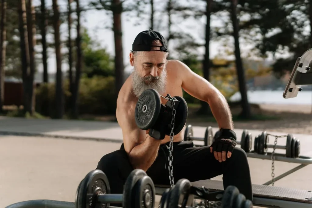 Strength Training and Functional Training: Unveiling the Differences 4 older man works on strength lifting weights outdoors.
