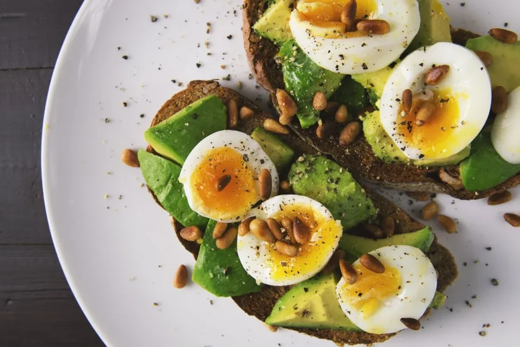 Starting Exercise at 40: 7 Essential Tips To Revolutionize Your Life 11 healthy plate of food with whole wheat bread, avocados, and sliced boiled eggs.