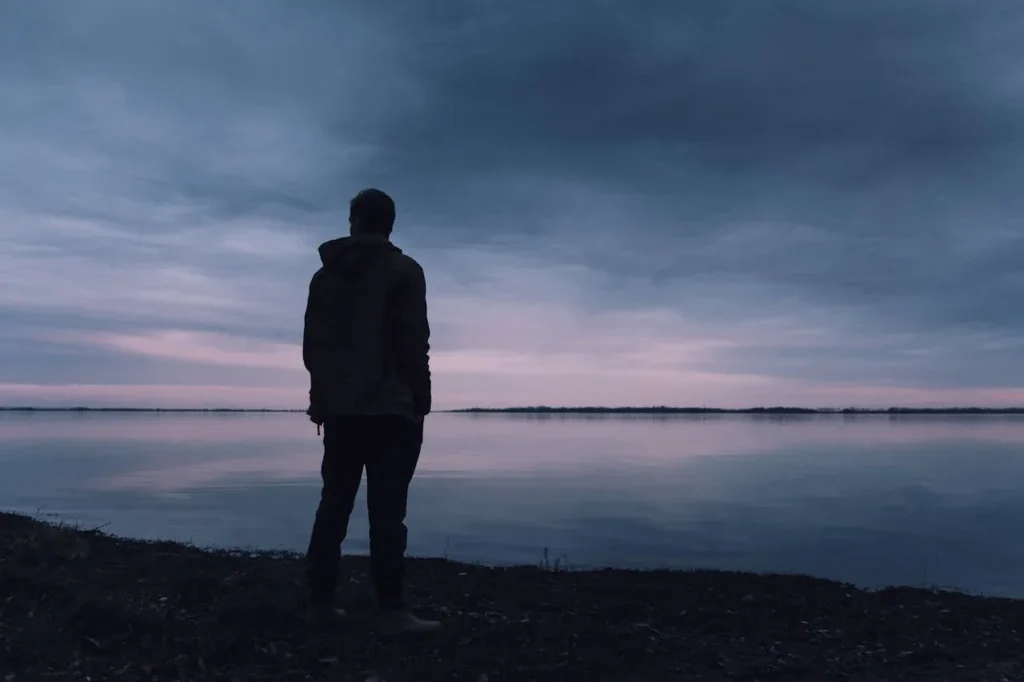 What is Strength: 6 Essential Elements 7 man standing beside lake at dusk