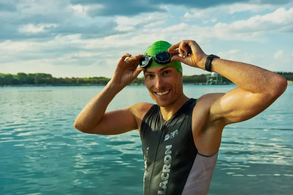 Discover 7 Powerful Exercise Benefits for Mental Health 7 man smiling for camera pulling on swim googles before jumping into a lake