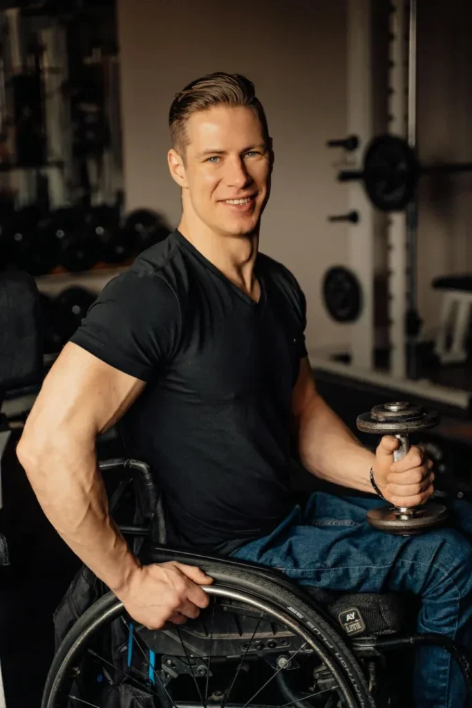 Discover 7 Powerful Exercise Benefits for Mental Health 4 man in wheelchair smiling in a gym feeling good that he is taking care of himself