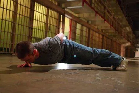 Convict Conditioning Review: A Journey Back to Strength 4 man doing one arm pushups