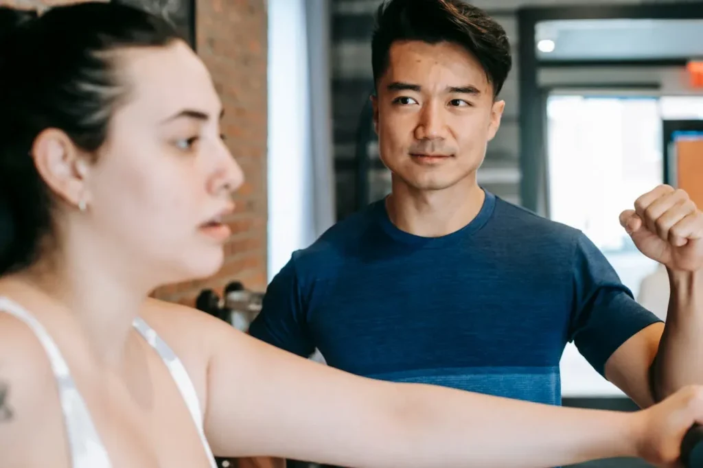 Starting Exercise at 40: 7 Essential Tips To Revolutionize Your Life 10 personal trainer encouraging his client