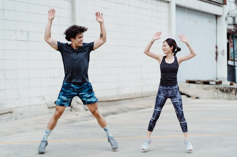 10 Simple Home Workouts for Beginners to Boost Fitness and Strength! 2 a fit couple doing jumping jacks