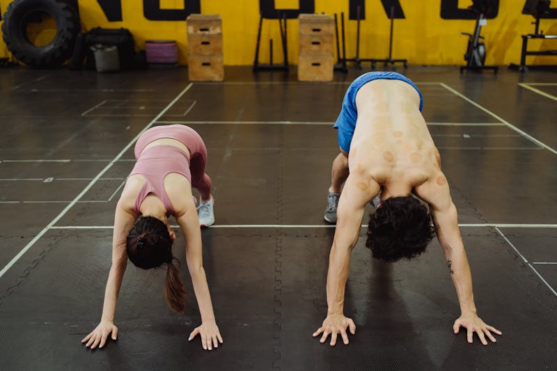Unlock Calisthenics Strength: 3 Calisthenics Routines 12 fit couple performing the pike pushup