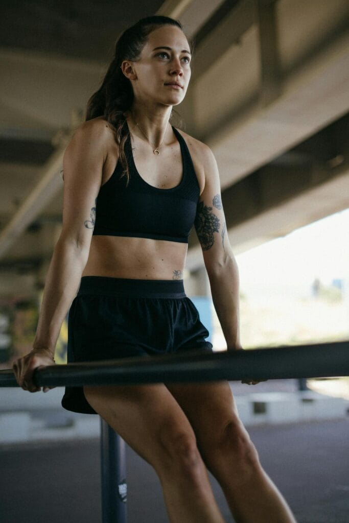 Unlock Calisthenics Strength: 3 Calisthenics Routines 11 woman doing dips on parallel bars