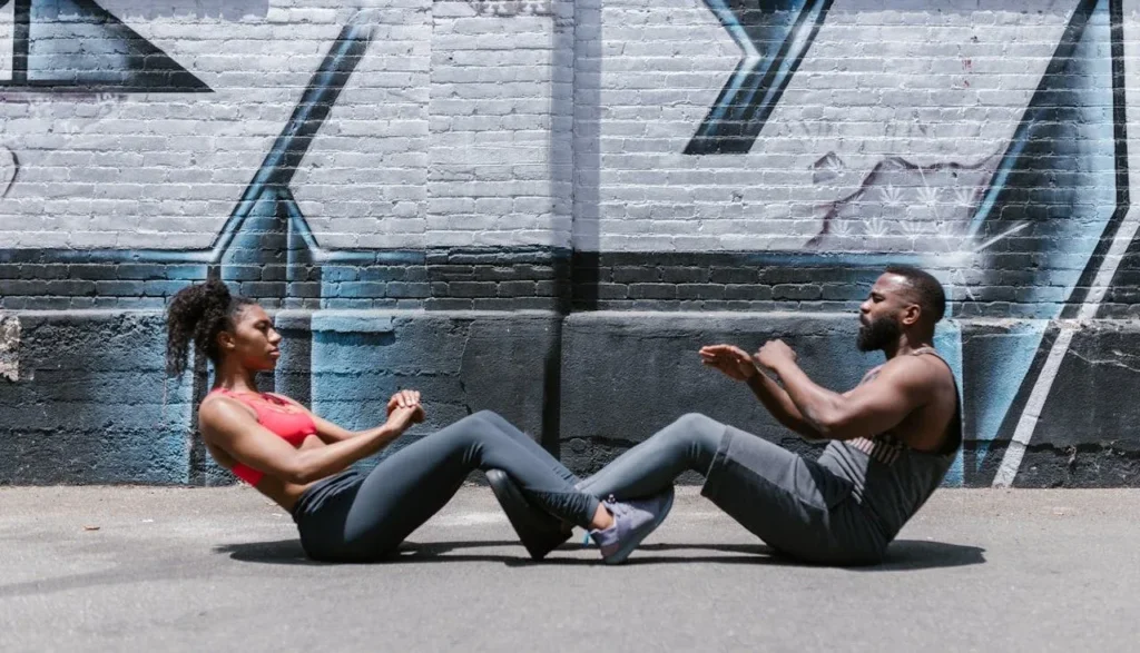 Rapid Fat Loss: 7 Powerful Fitness Hacks 2 man and woman doing sit-ups facing each other