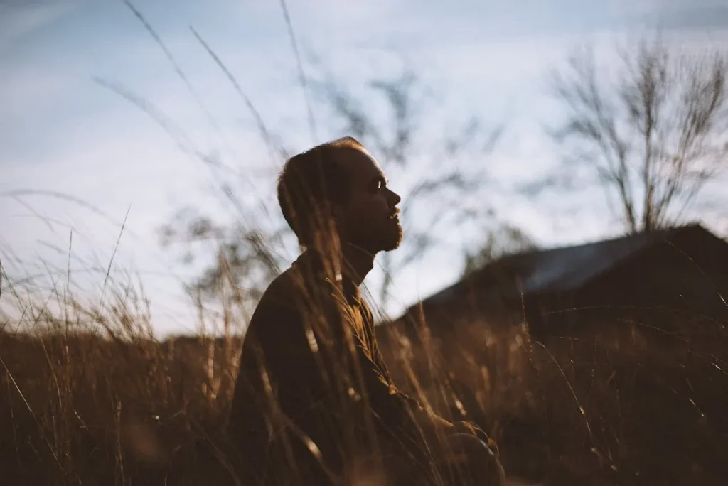Discover 7 Powerful Exercise Benefits for Mental Health 3 man seated in grassy field meditating