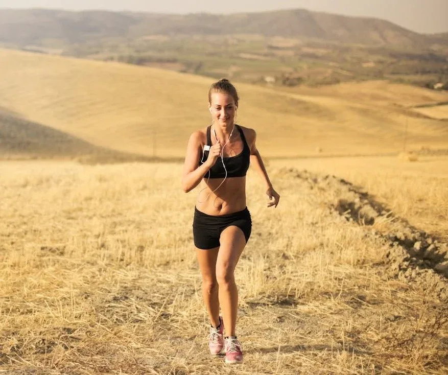 Discover 7 Powerful Exercise Benefits for Mental Health 2 exercise benefits for mental health - woman running in vast open field smiling