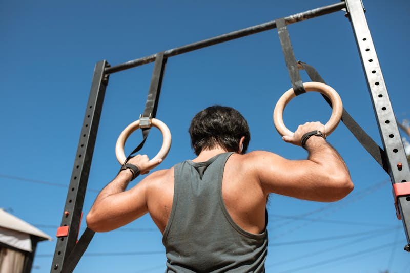 Bodyweight Exercises: 7 Incredible Workouts to Transform Your Fitness 2 man demonstrating ring pullups for bodyweight exercise
