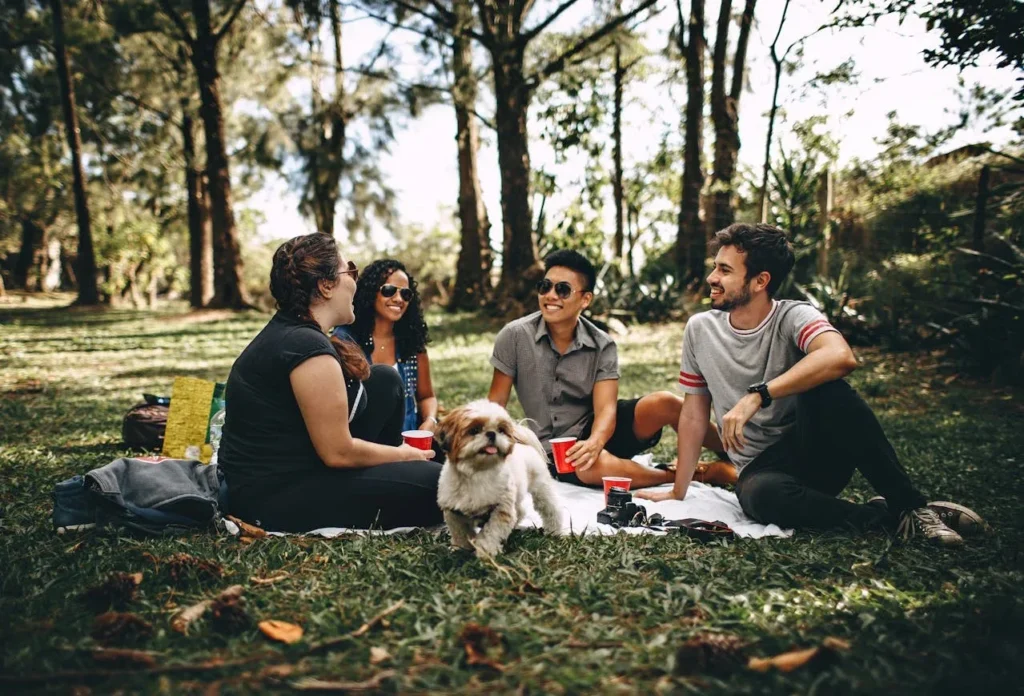 7 Surprising Health Benefits of Spending Time in Nature 7 group of people having a picnic in a forested park