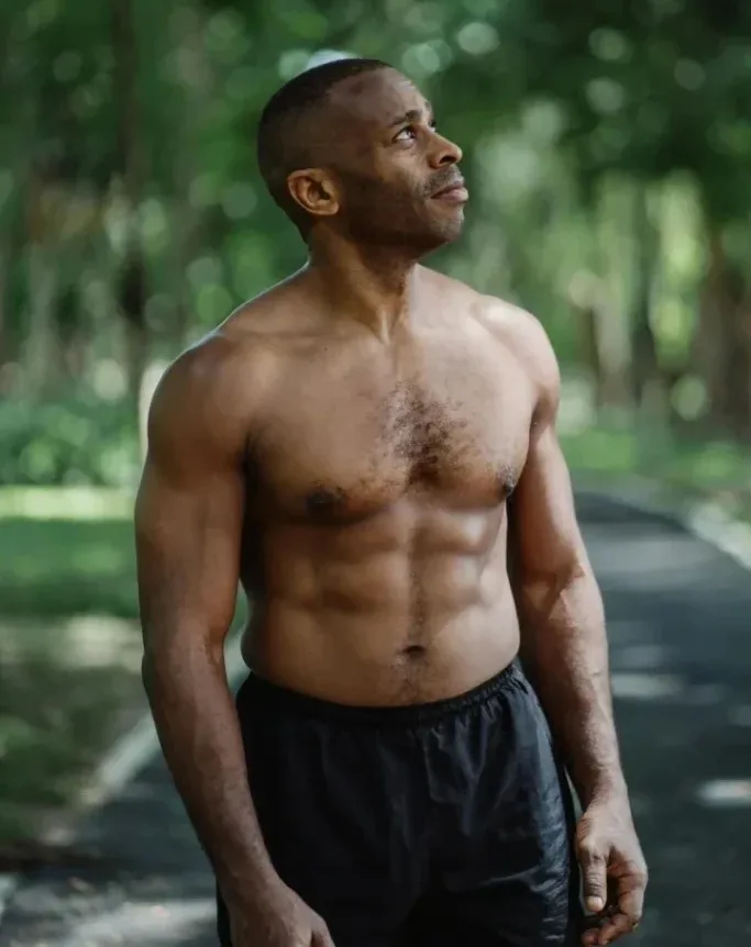 Calisthenics for Seniors: 7 Powerful Exercises to Boost Strength and Vitality 3 muscular older man appearing contemplative in a park