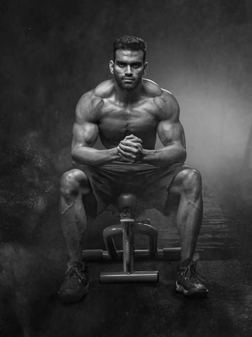 10 Incredible Protein Supplements for Strength Training: Maximize Your Gains 4 motivational fitness - muscular man in darkened gym
