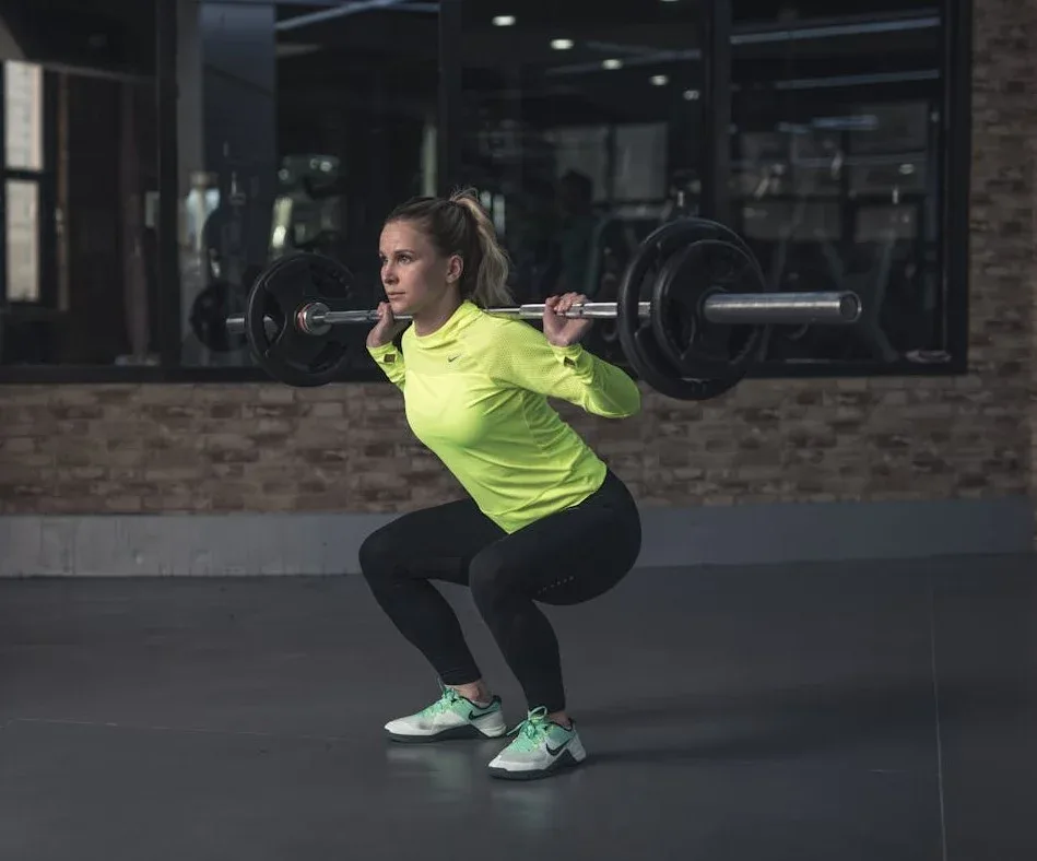 Strength Training Tips for Women: 10 Essential Strategies to Transform Your Fitness 3 woman doing weighted squats with great form