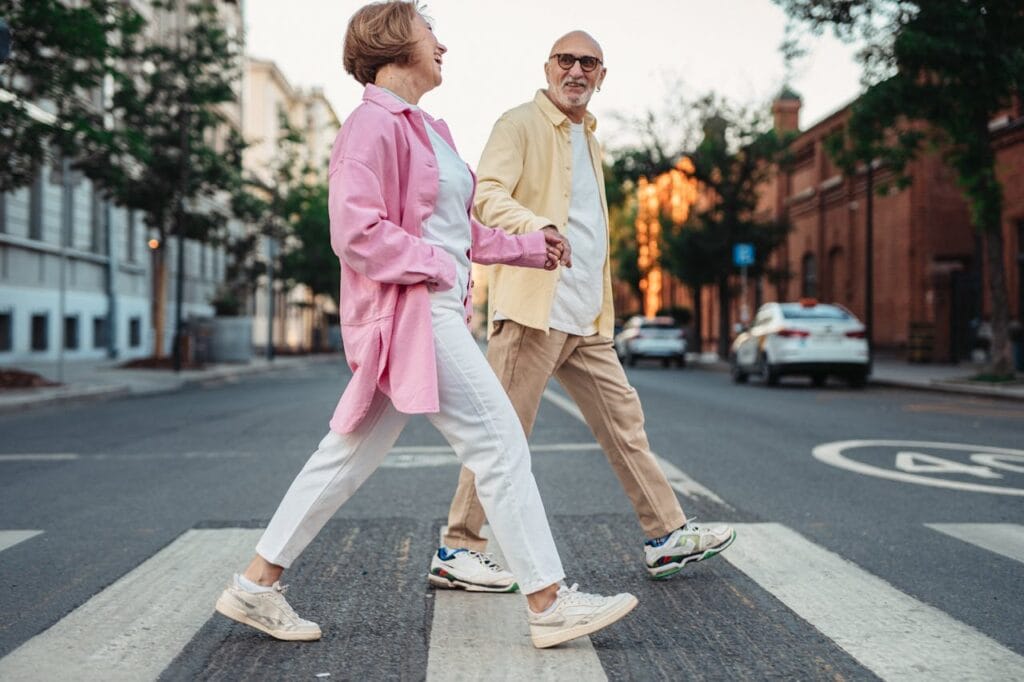 5 Easy Steps to Boost Senior Health and Wellness 2 senior health and wellness couple smiling and walking hand in hand.