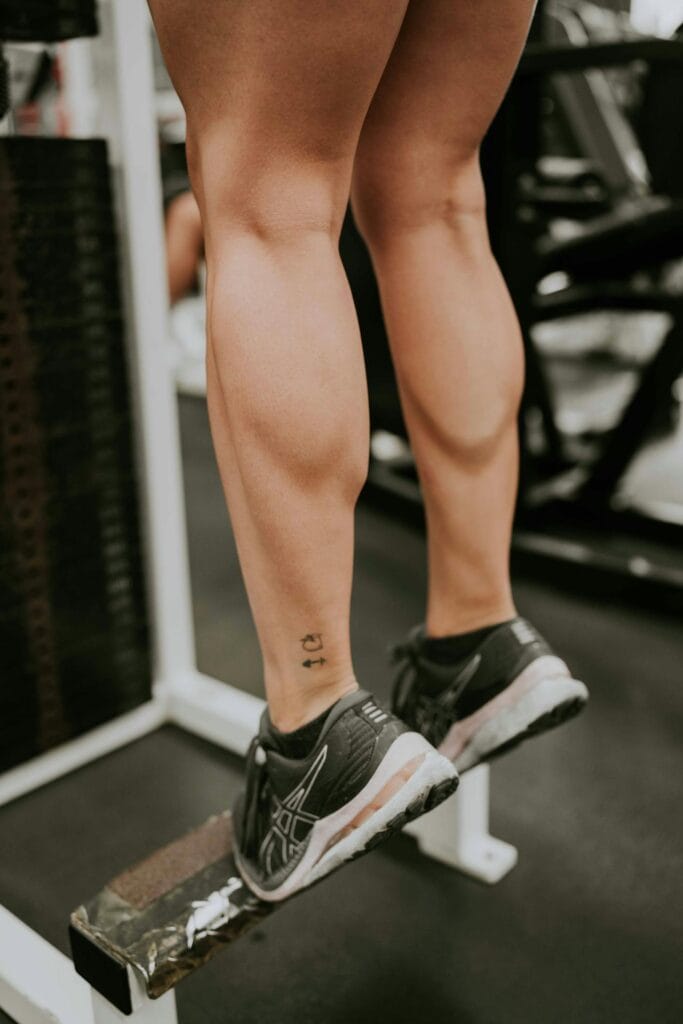 7 Simple Beginner Calisthenics for Seniors to Boost Strength and Mobility 5 image of doing calf raises at a machine in a gym