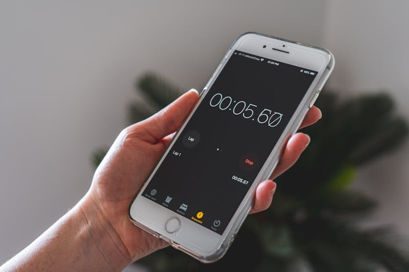 Transform Your Fitness: Quick 15-Minute Home Workouts for Busy People 3 hand holding a phone with timer app