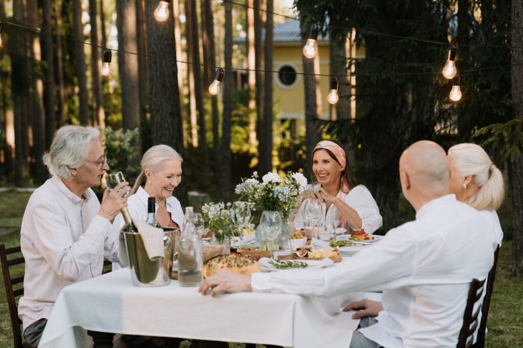 5 Easy Steps to Boost Senior Health and Wellness 5 senior men and women having dinner outside