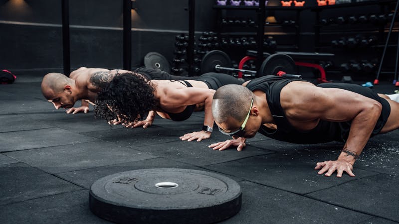 How to Master Bodyweight Training: 7 Steps to Achieve Incredible Strength and Endurance 3 three people performing a pushup