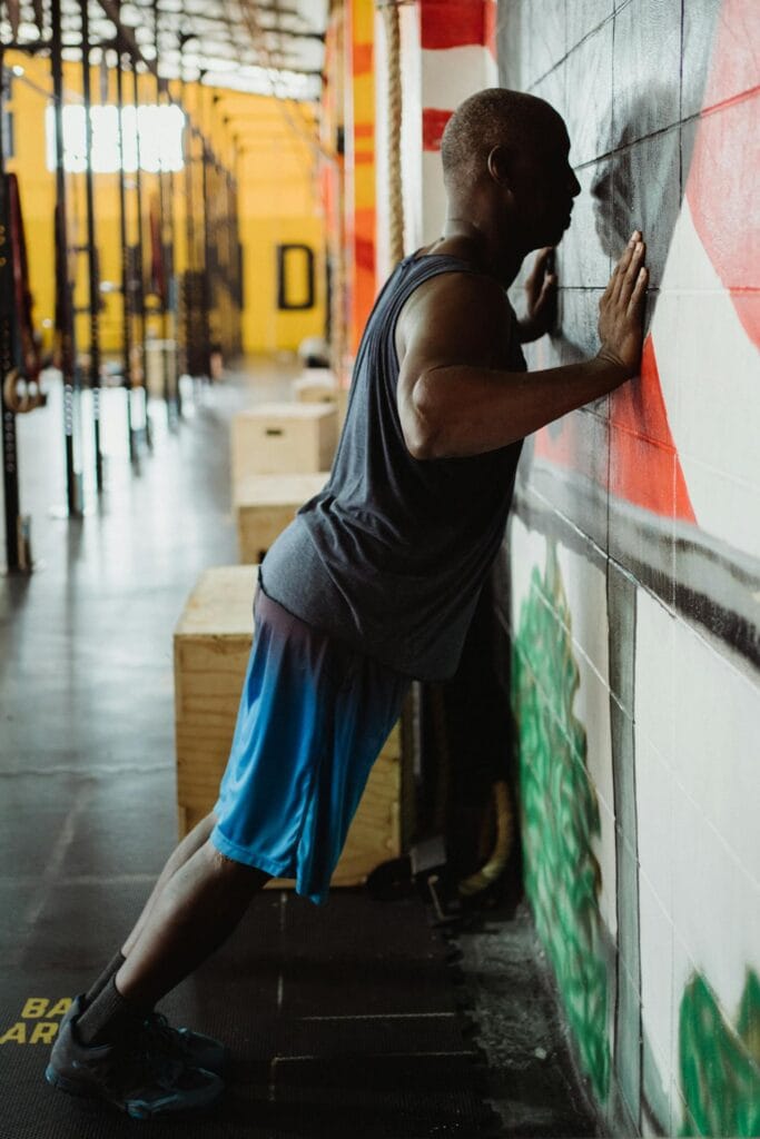 7 Simple Beginner Calisthenics for Seniors to Boost Strength and Mobility 3 man doing wall pushups to demonstrate calisthenics for seniors to boost strength and mobility