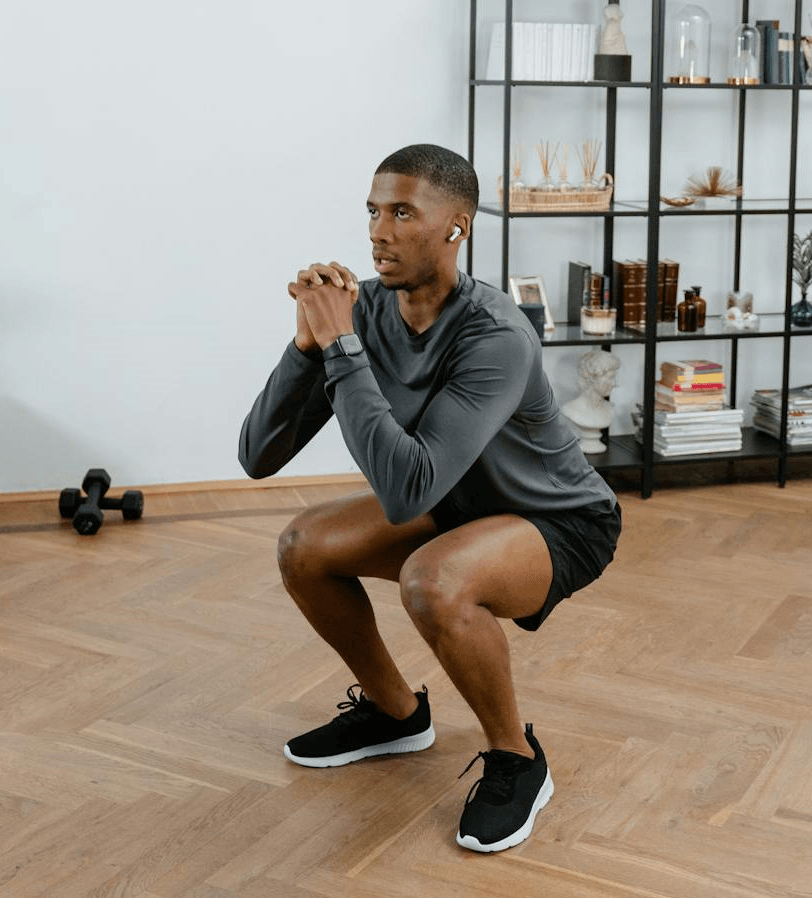 7 Powerful Leg Exercises Without Weights for Ultimate Strength 4 man doing squats at his home for leg exercises without weights