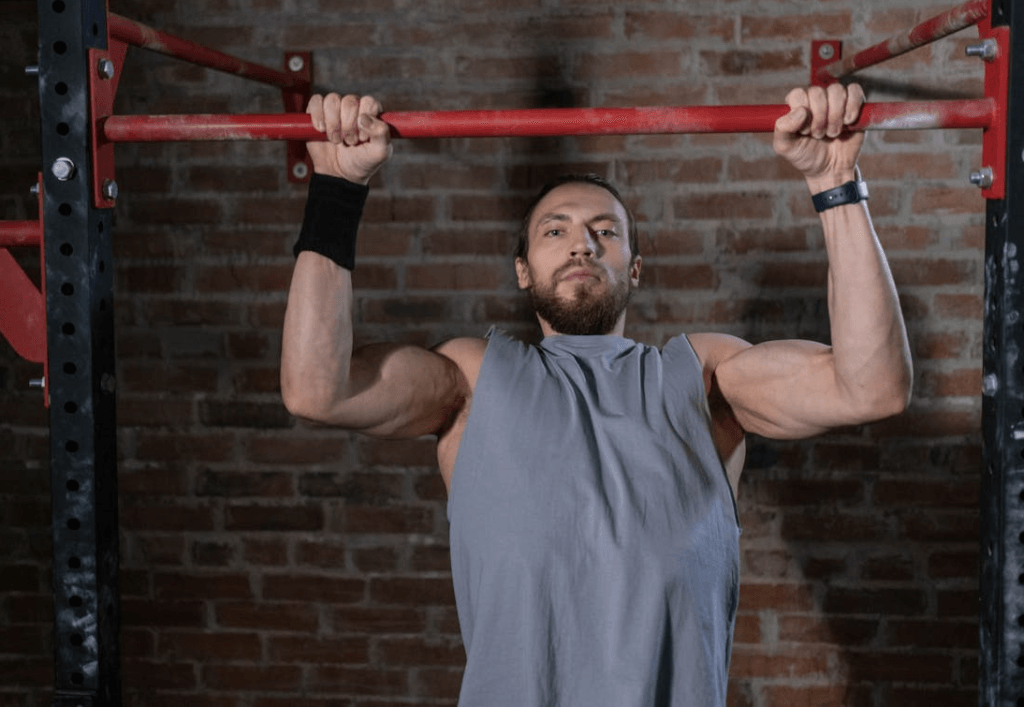 Unlock 8 Different Pull Ups for All Levels: Beginner to Advanced 3 image of man doing an eccentric lowering of a pull up