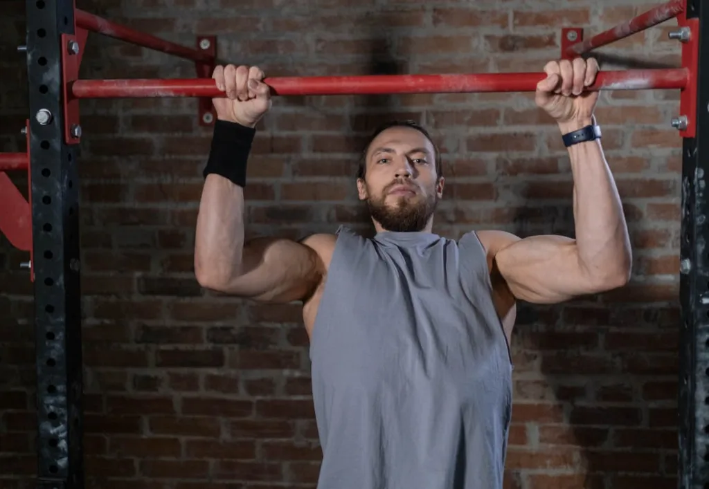image of man doing an eccentric lowering of a pull up