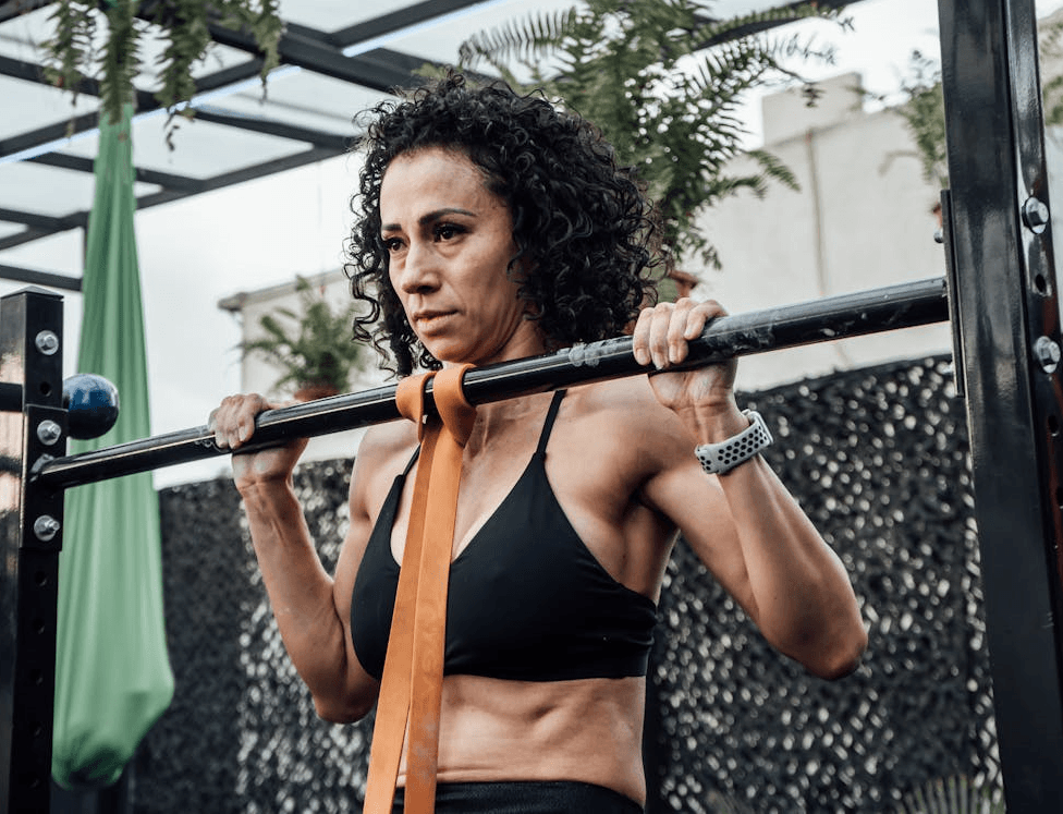 Unlock 8 Different Pull Ups for All Levels: Beginner to Advanced 4 woman using resistance band to do pull ups