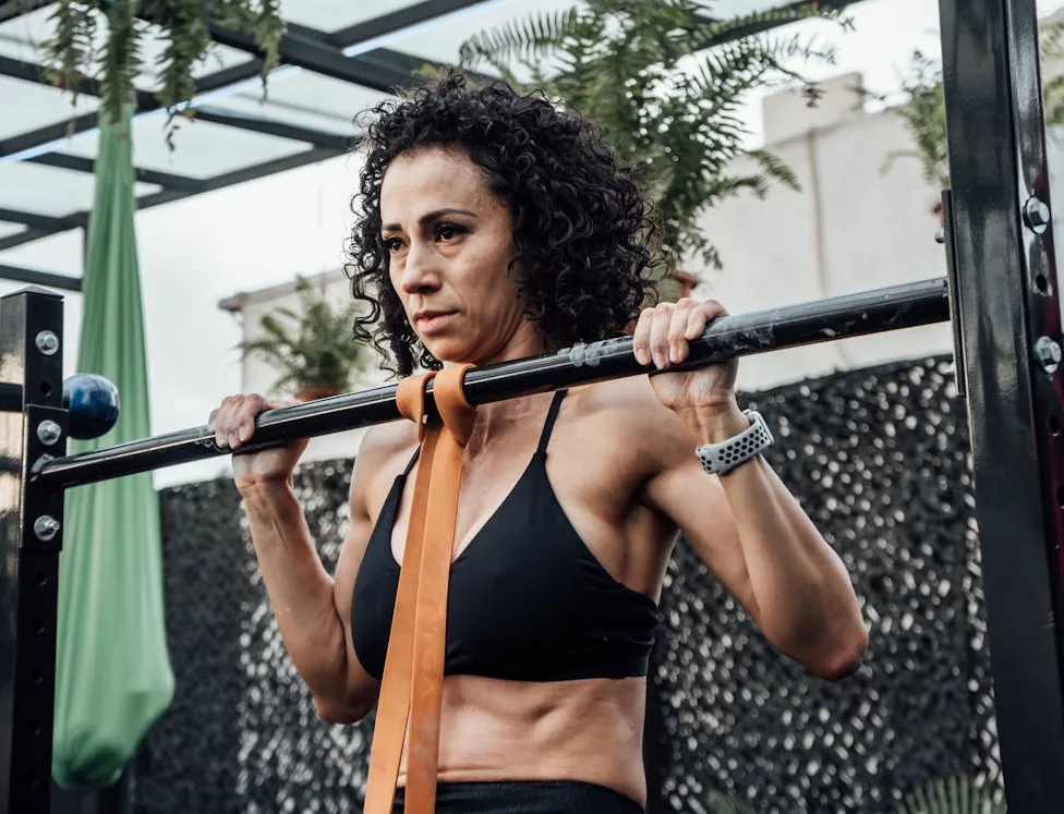 woman using resistance band to do pull ups