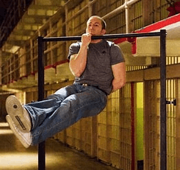 Unlock 8 Different Pull Ups for All Levels: Beginner to Advanced 8 man performing a one arm pull up at the top position