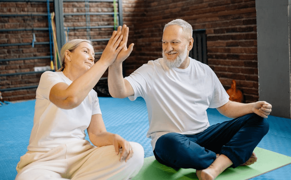 Get Strong, Stay Strong: Senior Workouts Without Equipment 9 older couple giving the high five after a good workout