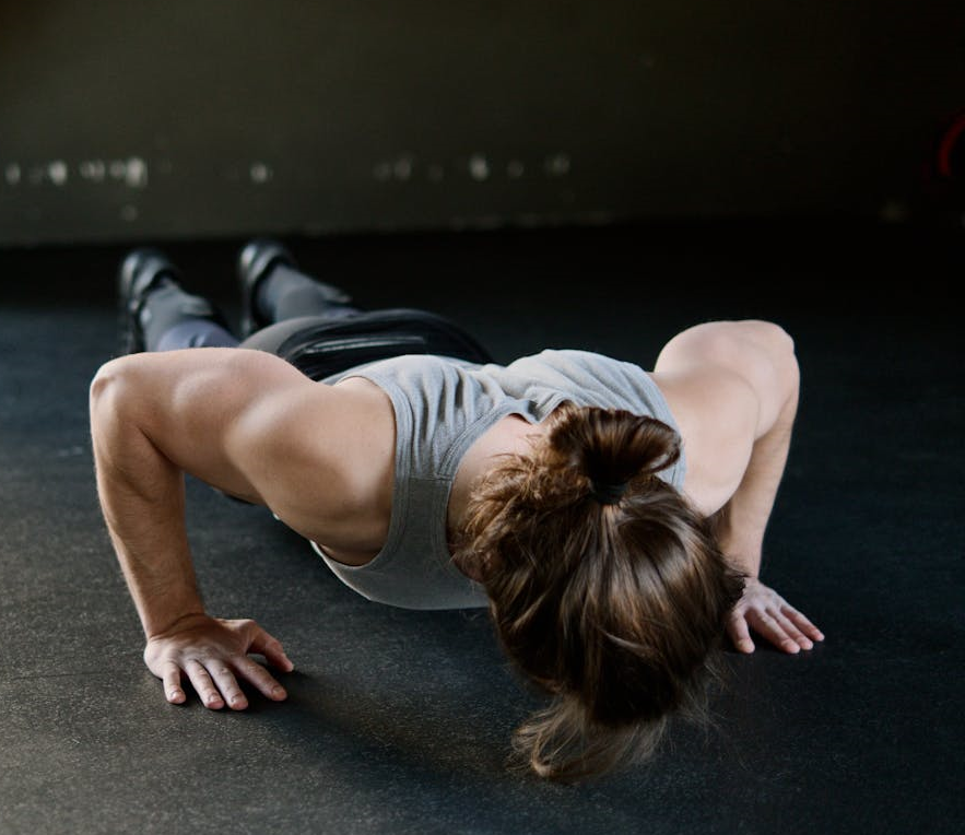 7 Powerful Hotel Workouts Without Equipment to Keep You Fit on the Go! 4 man doing pushups in a darkened room