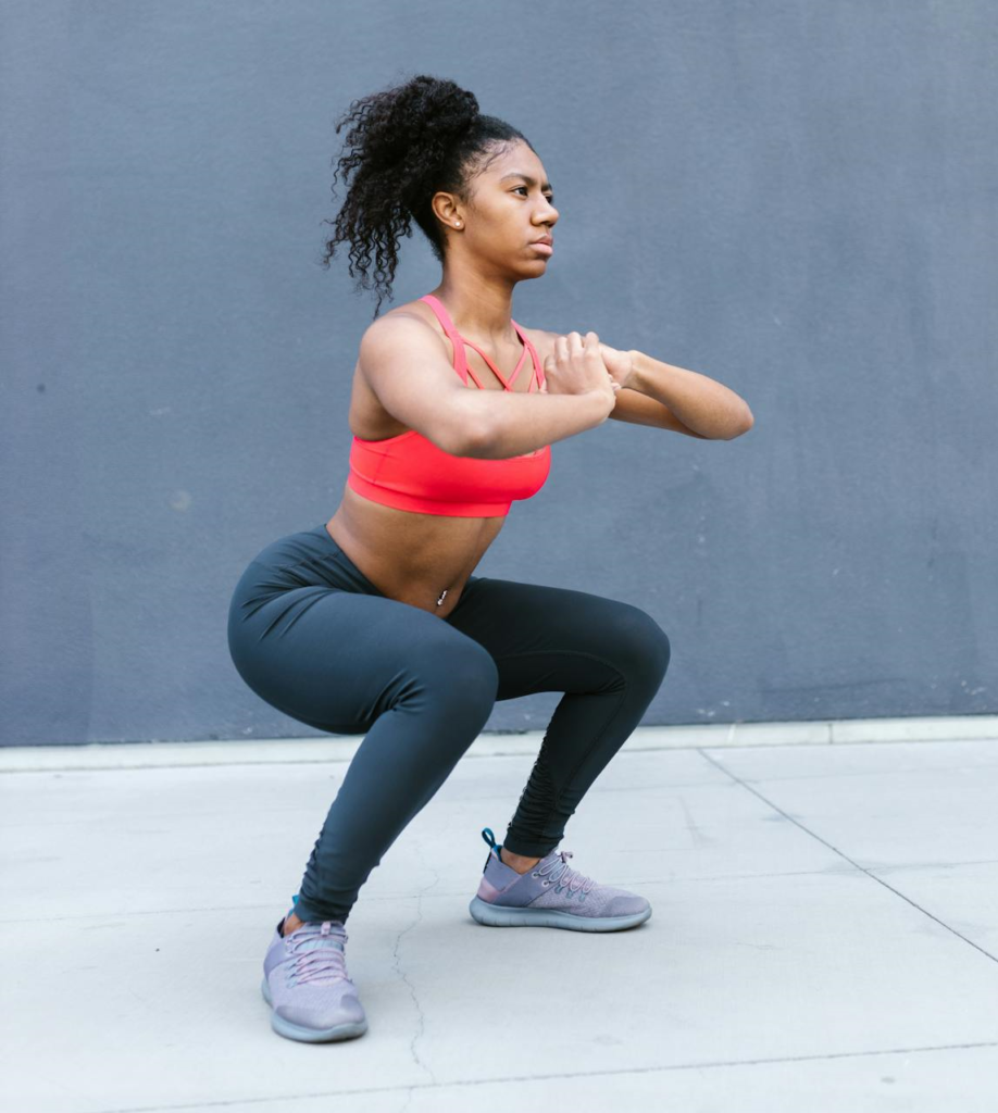 7 Powerful Hotel Workouts Without Equipment to Keep You Fit on the Go! 3 woman performing perfect bodyweight squats