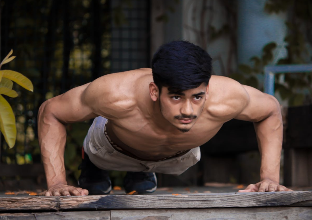 How to Master Different Push Ups: 7 Progressions for Strength and Fitness 4 man doing wide push ups in an open air room