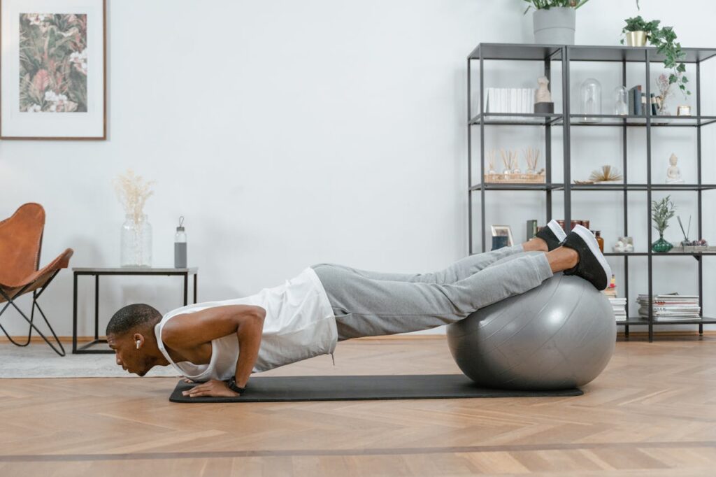 How to Master Different Push Ups: 7 Progressions for Strength and Fitness 5 man doing decline pushups with exercise ball beneath his feet