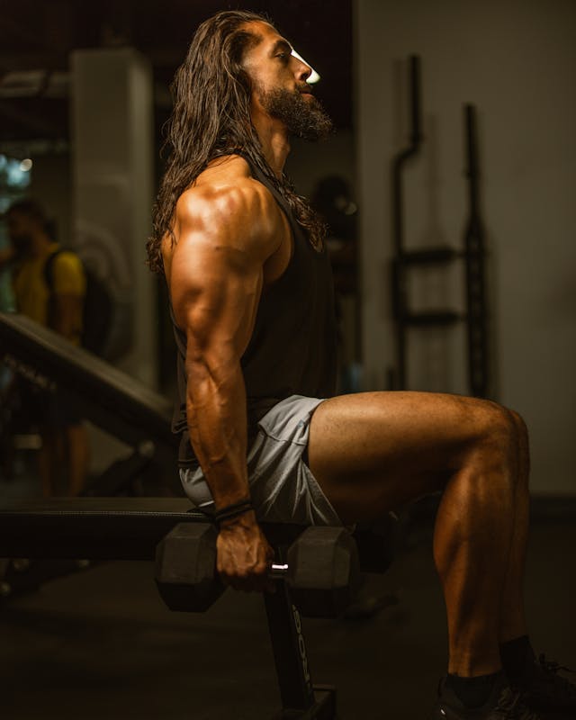 How to Lose Fat Fast for Beginners: Top Adjustable Dumbbells to Kickstart Your Weight Loss 6 muscular man seated on a workout bench holding dumbbells