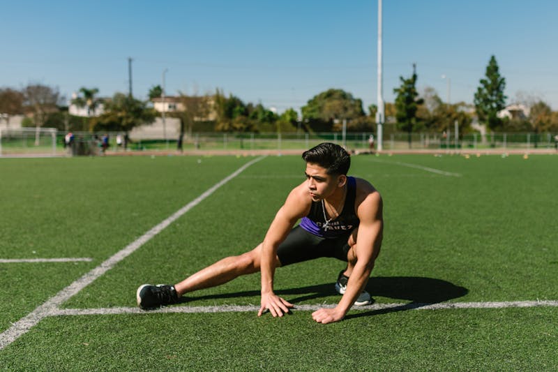 7 Powerful Leg Exercises Without Weights for Ultimate Strength 2 man working on side lunges on an athletic field