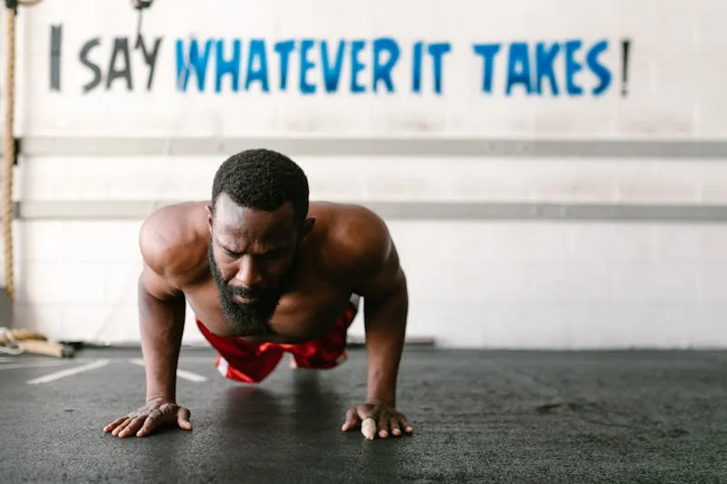 man demonstrating a calisthenics exercise by doing pushups