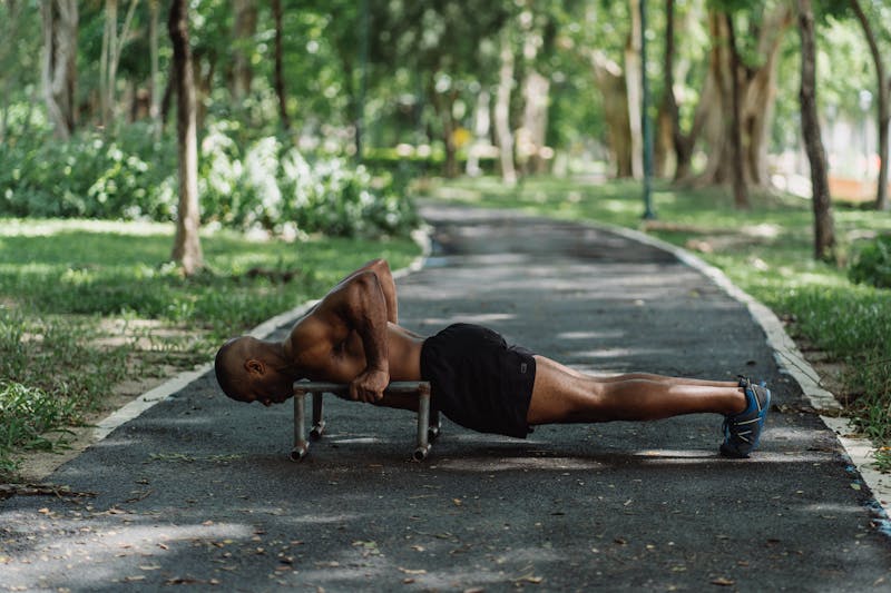 Full-Body Bodyweight Workout: A Dynamic 5 Step Plan 4 man in park using pushup handles while doing pushups