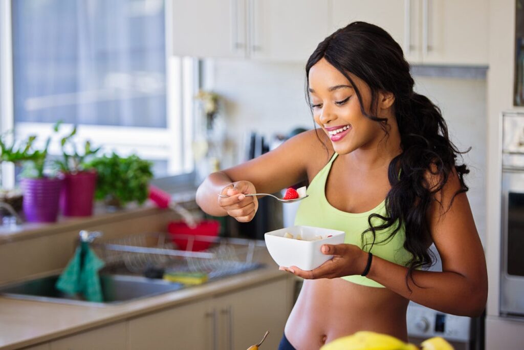 Intermittent Fasting: 5 Powerful Steps on How to Lose Belly Fat Fast 4 image of happy fit woman eating a healthy meal