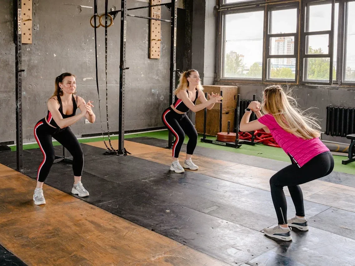 Unlock Calisthenics Strength: 3 Calisthenics Routines 3 Women doing air squats