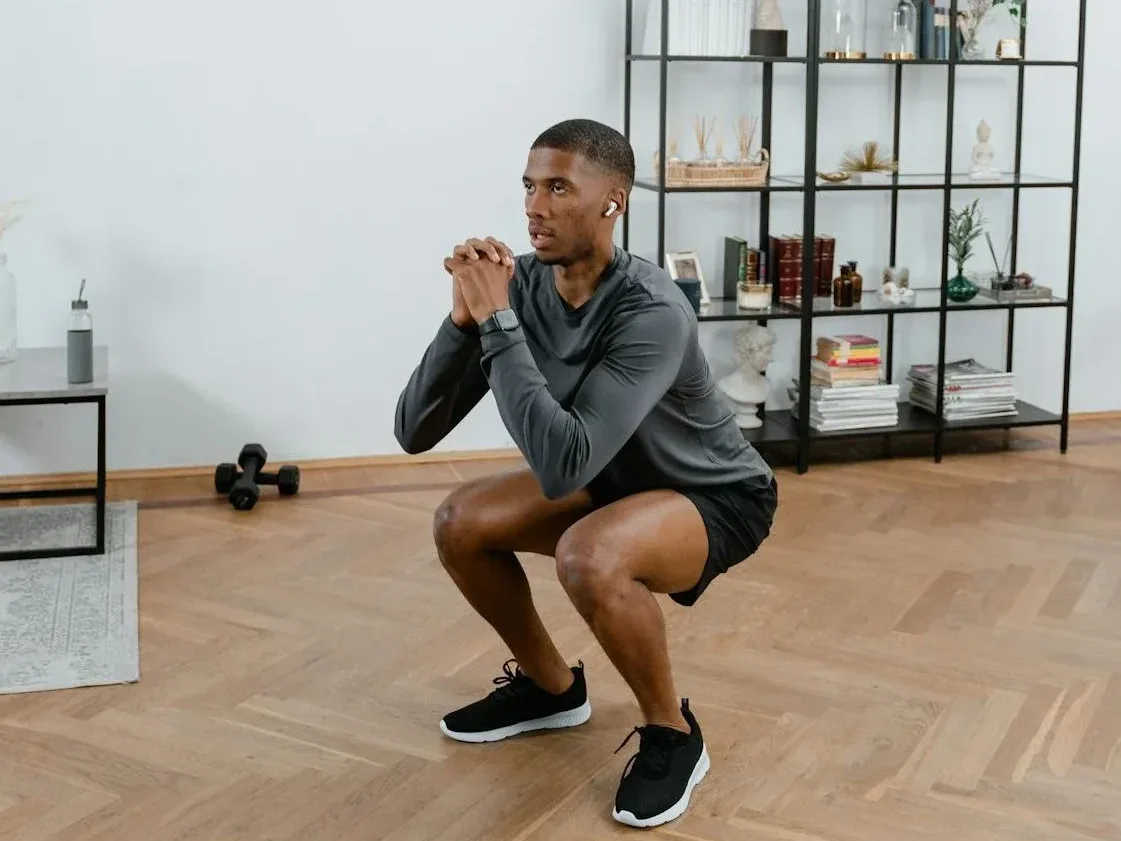 Bodyweight Exercises: 7 Incredible Workouts to Transform Your Fitness 5 man doing air squats at home