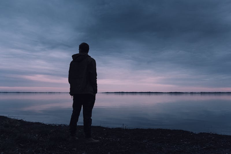 How to Get Lean and Stay Lean: 7 Powerful Strategies for Lasting Results 9 man looking out over a dark sky and lake
