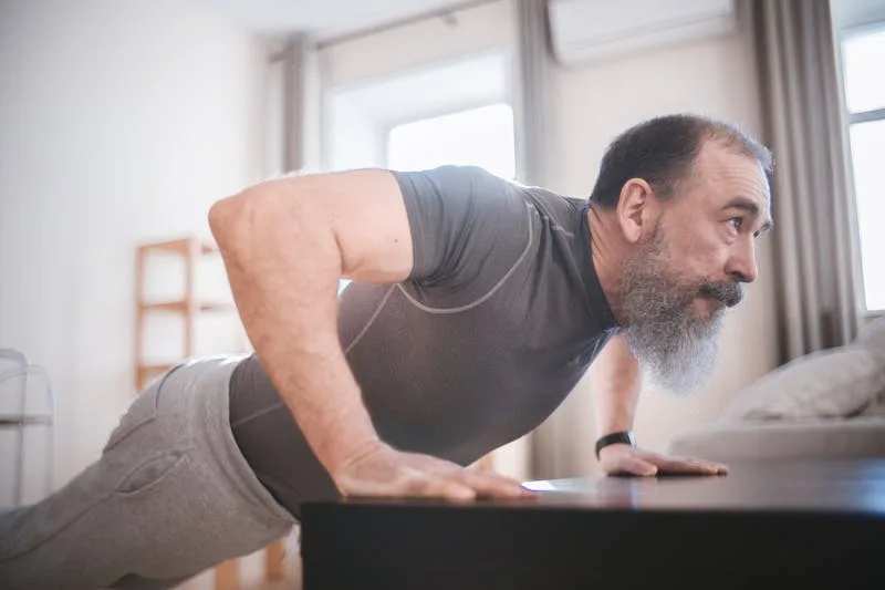 man doing incline pushups at home demonstrating how to get lean and stay lean