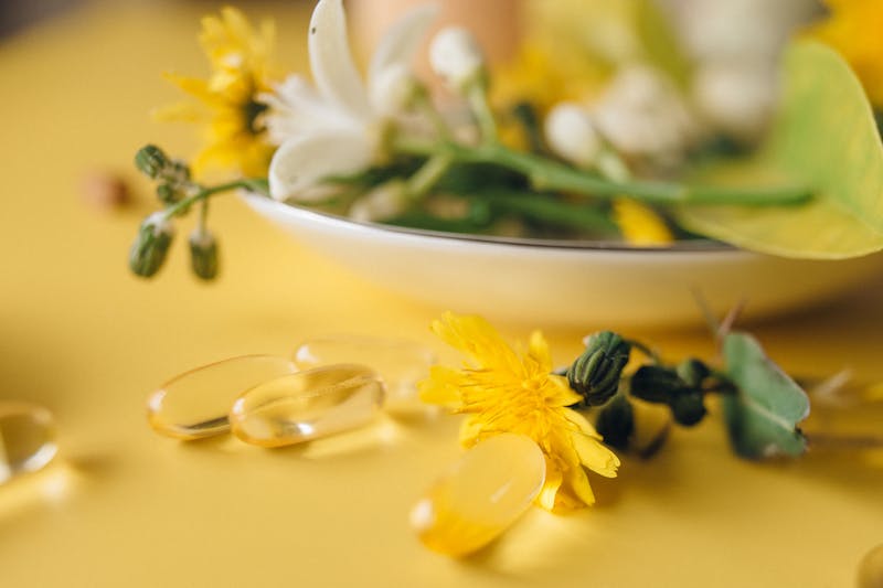 Why Is It So Hard to Lose Weight with PCOS? Proven Strategies for Success 7 an image of gel caps next to a decorative plate of flowers