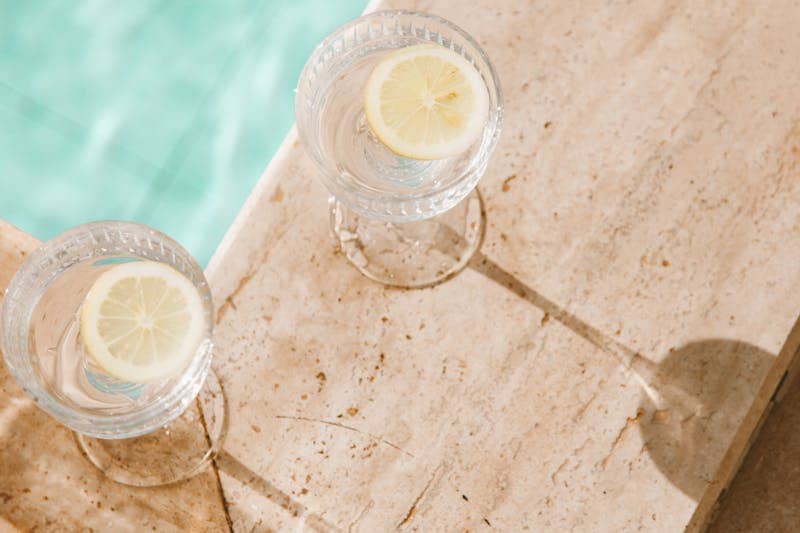 How to Get Lean and Stay Lean: 7 Powerful Strategies for Lasting Results 5 image of two glasses with water and lemon poolside