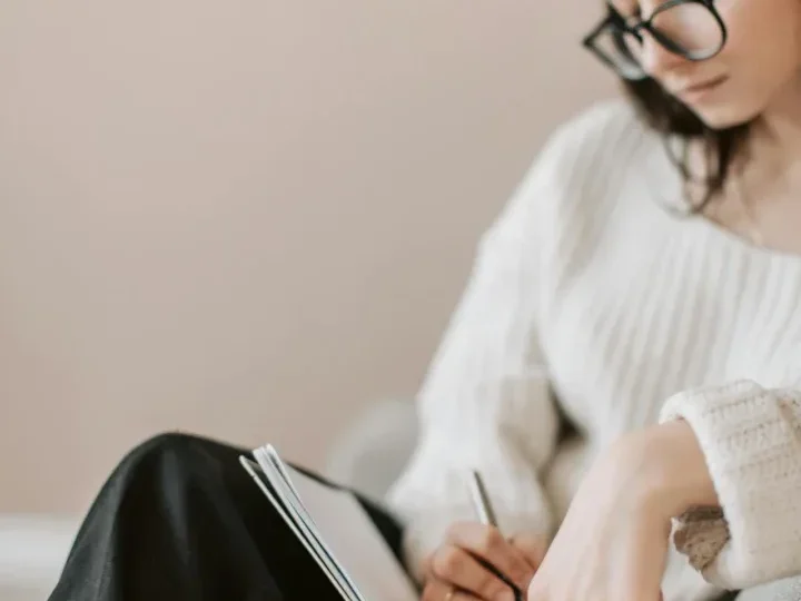 Safe Workout Tips for Those with Chronic Pain: 7 Empowering Strategies to Start Today 7 a woman writing in her journal