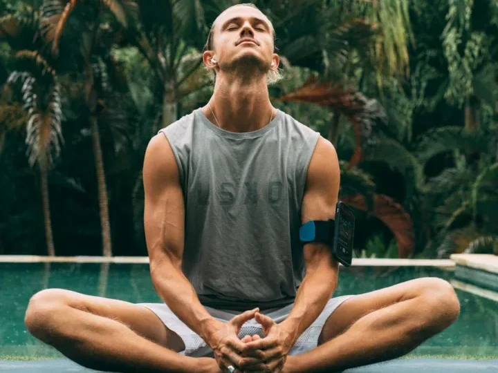 Discover 7 Powerful Exercise Benefits for Mental Health 13 man seated next to tropical pool meditating