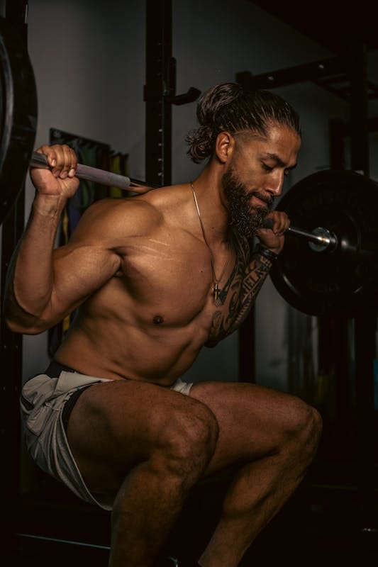Unlock Functional Strength: 7 Powerful Beginner Exercises for Real-World Strength 3 man performing squats with a barbell