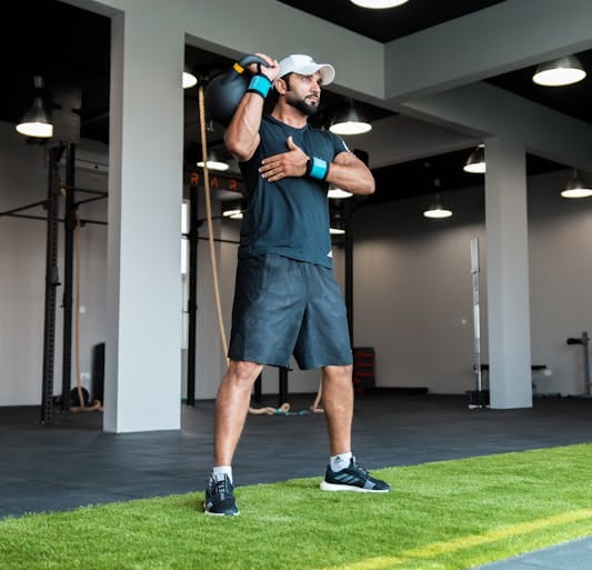Farmer Strength Training: 6 Powerful Moves for Total Body Strength 3 man doing single overhead kettlebell press